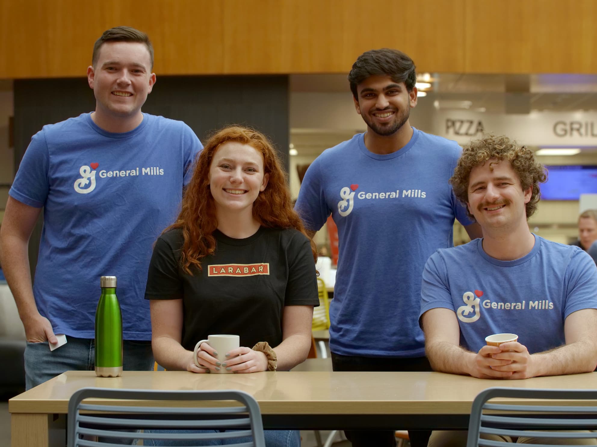 Four General Mills interns smiling at the camera